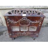 A French cast iron and brown treacle glazed enamel stove of rectangular form, with pierced cover and