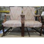 A pair of Georgian style open armchairs loosely in the Gainsborough style with floral patterned