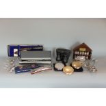 A box of interesting items to include silver plated tables wares, lighter, thimbles, binoculars,
