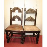 A near pair of 18th century oak Yorkshire side chairs, with carved rails, solid seats and turned