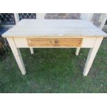 A 19th century pine scrub top kitchen table of rectangular form with rounded corners over a frieze