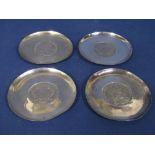 Four continental white metal trinket dishes, each inset with an Austrian Thaler, 7oz approx (4)