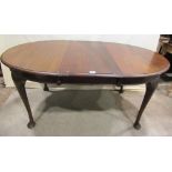 A Victorian mahogany wind out extending dining table of rectangular form with moulded outline and