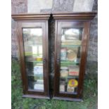 A pair of small Edwardian walnut wall mounted display cabinets, each enclosed by a rectangular