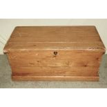 A Victorian stripped and waxed pine blanket box with hinged lid, and candle box to interior