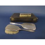 Cased part fitted dressing set comprising two silver brushes and mirror, the case 33cm long