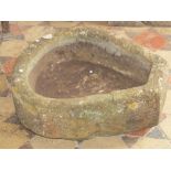 A small unusual natural stone horseshoe shaped trough, with single squared off end, 55cm x 50cm
