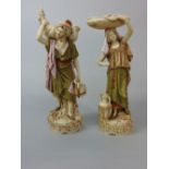 A pair of late 19th century Royal Dux figures of eastern style male and female water carriers,