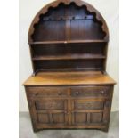 A good quality reproduction oak dresser, the base enclosed by a pair of panelled doors with two