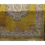 Chinese full pile wool carpet, with typical pastel floral decoration upon a mustard ground, 400 x