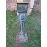 A heavy weathered cast iron architectural column/support of square tapered and flared form with