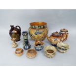 A collection of Doulton ceramics including a jardiniere with stylised floral and foliate detail,