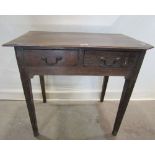 A country made oak side table fitted with two frieze drawers raised on four square tapered and