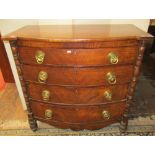 A Regency mahogany bow fronted chest of four long drawers with turned column supports, crossbanded