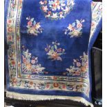 Chinese full pile wool rug with typical pastel floral panels upon a royal blue ground, 260 x 150cm