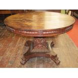 A Regency rosewood centre table, the circular top raised on a square cut column with acanthus and