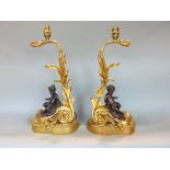 Good pair of bronze and ormalu chanets, modelled as reclined cherubs on rococo type foliate bases,