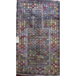 Baluchi village rug, with multi-coloured geometric decoration upon a dark ground, 145 x 90cm