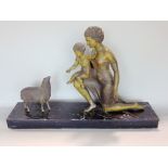Art Deco spelter character group of a child on his mothers knee feeding sheep, upon a black marble
