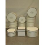 Seven sets of three graduated presentation boxes of cylindrical form with cream colourway with black
