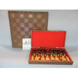 'The Lewis Chess Set' comprising a hardwood box fitted with various carved figural chess pieces