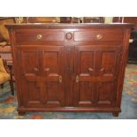 A substantial 18th century oak buffet enclosed by a pair of quarter panelled doors and two frieze