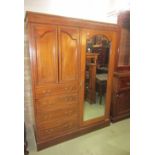 An inlaid Edwardian mahogany compactum wardrobe with boxwood and repeating lozenge shaped banding