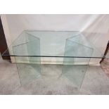 A three sectional plate glass dining table or desk, the rectangular top raised on a pair of curved