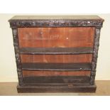 A Victorian dark stained oak floorstanding open bookcase with two adjustable shelves flanked by