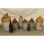 A collection of stoneware flagons, bottles and further advertising wares, to include a two gallon