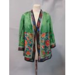 Early 20th century Chinese jacket in green silk embroidered with floral designs including petals