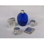 Mixed bijouterie lot to include a silver lighter, a silver vesta case, two silver topped jars and