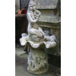 A weathered contemporary three sectional garden water feature/fountain in the form of a kneeling