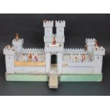 Vintage model fort with wooden walls, turrets and base with painted character figures