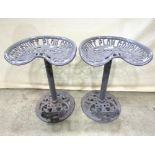 A pair of novelty grey painted cast metal stools in the form of vintage tractor seats with pierced