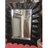 A large contemporary japanned composite wall mirror of rectangular form with bevelled edge plate