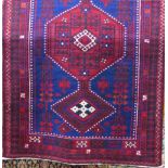 Good quality eastern rug with three red medallions upon a navy blue ground, 250 x 170cm