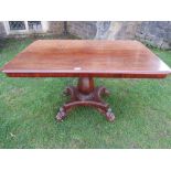 A Regency mahogany centre table, the mahogany top raised on an octagonal vase shaped pillar,