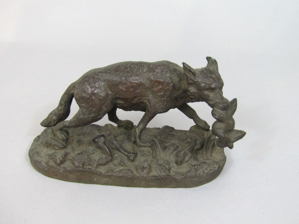 Cast bronze character group of a fox carrying a bird in its mouth set on a naturalistic base,