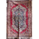 Full pile Keshan rug with central floral medallion, upon a red and cream ground, 180 x 120cm
