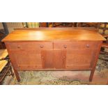 An oak sideboard by Heal's, the front elevation enclosed by two drawers and two panelled cupboard