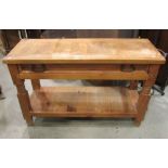 A stripped pine side/serving table with shallow frieze drawer raised on bobbin and block supports