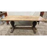 An old English style oak refectory table, the rectangular planked top with cleated ends raised on