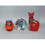 A collection of Poole Pottery wares comprising a red glazed model of a seated cat, 29.5cm tall a