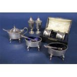 Five piece early 20th century silver cruet comprising two salts, mustard with original blue glass