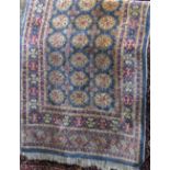 Persian full pile Bokhara type rug with typical geometric cream medallions upon a light blue ground,