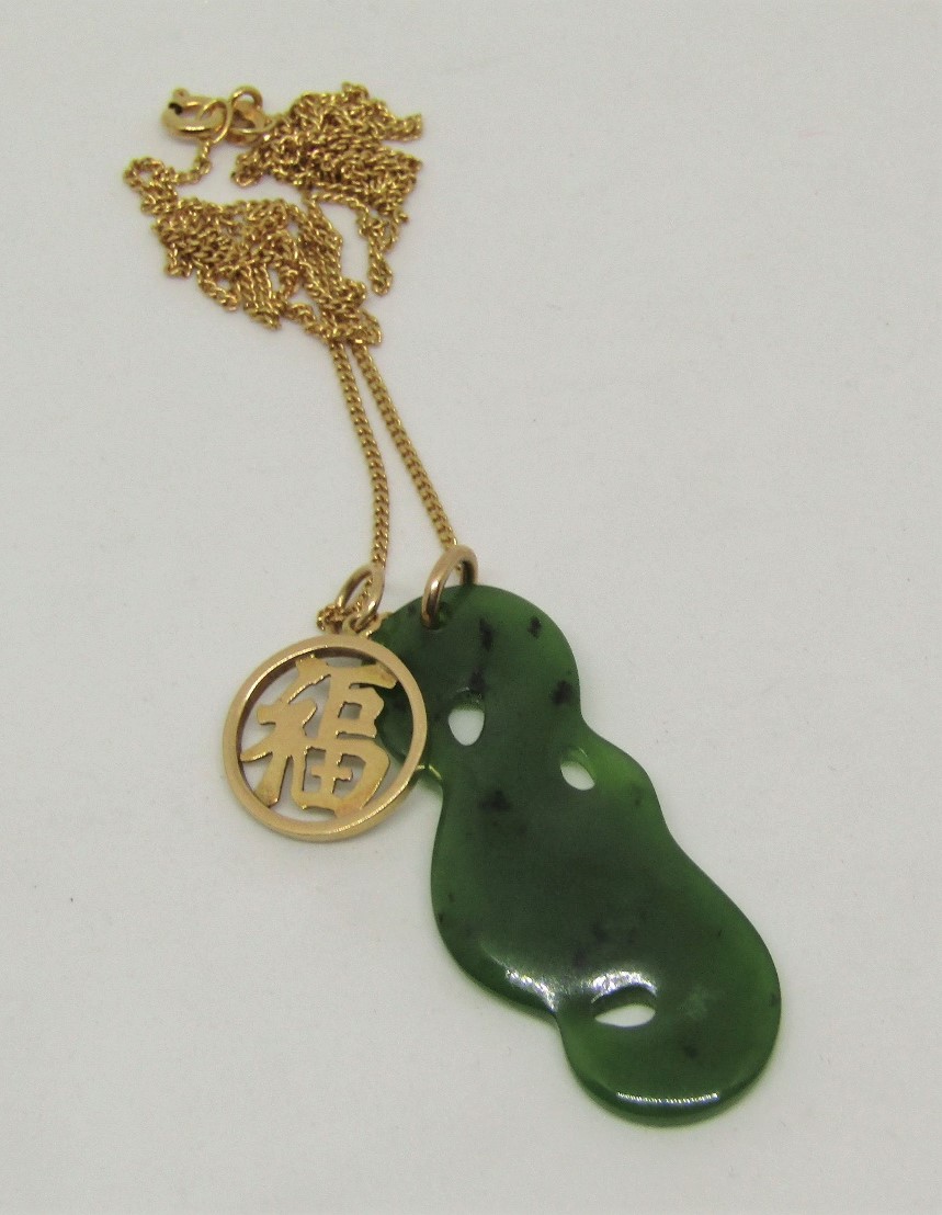 9ct fine link necklace hung with a carved nephrite pendant and a further 14k pendant of circular