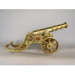 Cast polished brass scale model of a canon, 46cm long