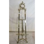 A cast brass floorstanding easel with decorative pierced and scrolling acanthus detail
