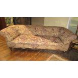 A Victorian Chesterfield sofa of usual form, raised on turned supports, 215cm